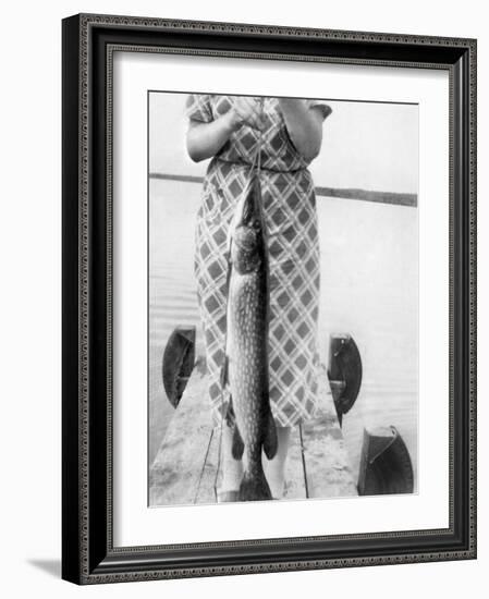 Woman Holds on Large Northern Pike on a Lake Pier, Ca. 1950-null-Framed Photographic Print