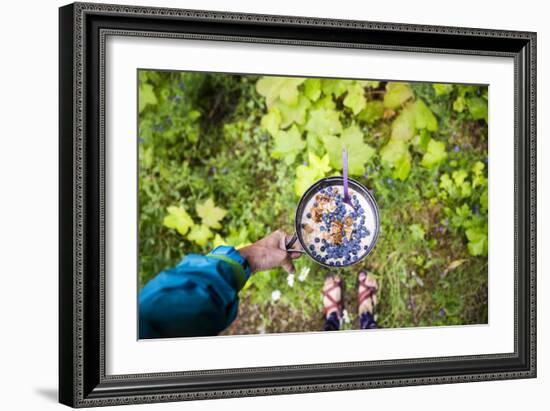 Woman Holds Out Her Breakfast Of Oats And Wild Huckleberries While Backpacking During The Summer-Hannah Dewey-Framed Photographic Print