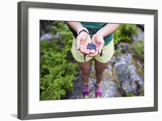 Woman Holds Out Wild Huckleberries She Picked While Hiking-Hannah Dewey-Framed Photographic Print