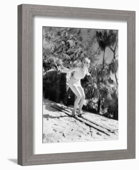 Woman in a Bathing Suit Skiing Down a Hill-null-Framed Photo