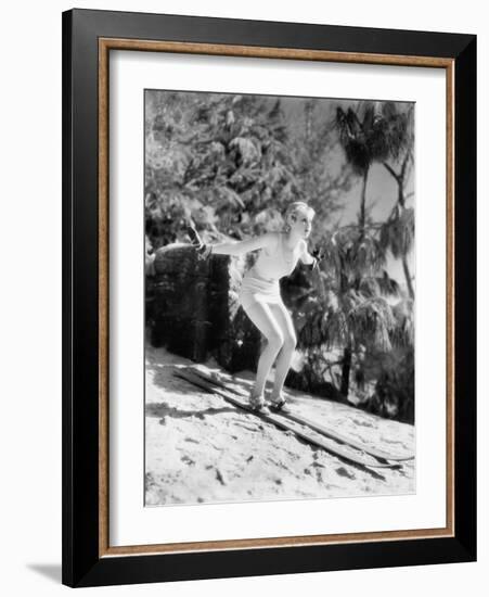 Woman in a Bathing Suit Skiing Down a Hill-null-Framed Photo