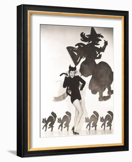 Woman in Cat Costume Posing Against Halloween Themed Wall-null-Framed Photo