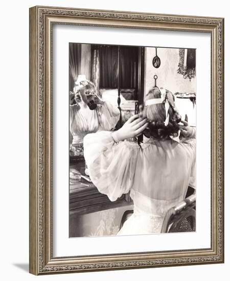 Woman in Gas Mask Looking in Mirror-null-Framed Photo