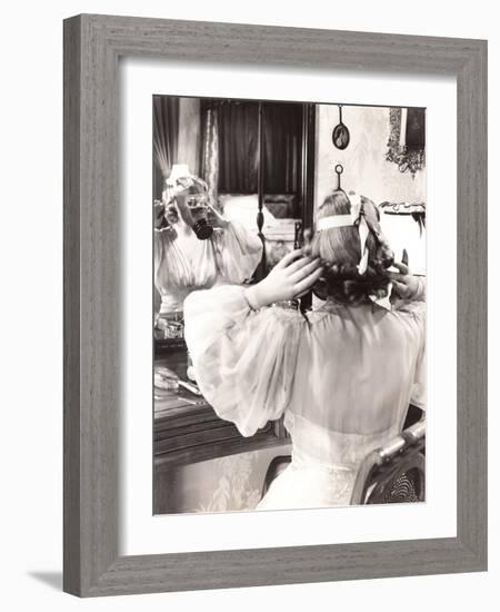 Woman in Gas Mask Looking in Mirror-null-Framed Photo