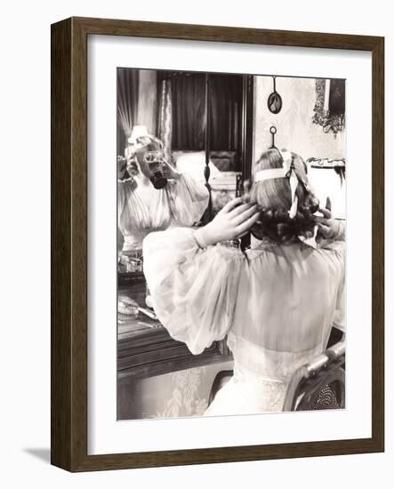 Woman in Gas Mask Looking in Mirror-null-Framed Photo