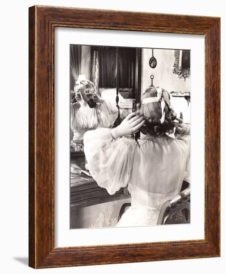 Woman in Gas Mask Looking in Mirror-null-Framed Photo