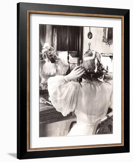 Woman in Gas Mask Looking in Mirror-null-Framed Photo