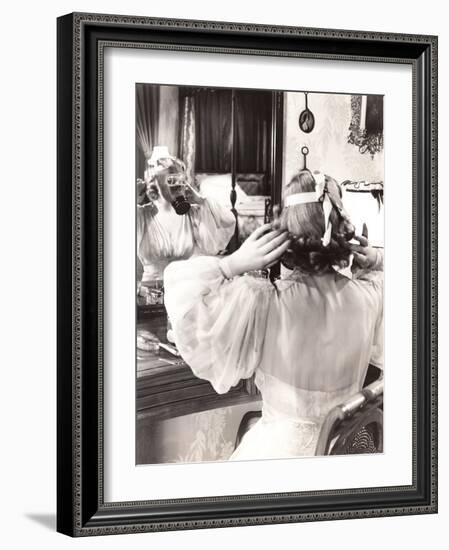 Woman in Gas Mask Looking in Mirror-null-Framed Photo