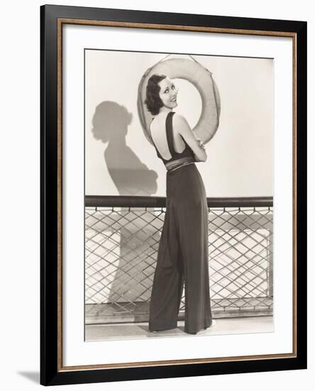 Woman in Jumpsuit Posing by Life Preserver-null-Framed Photo