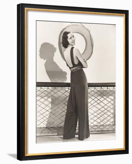 Woman in Jumpsuit Posing by Life Preserver-null-Framed Photo