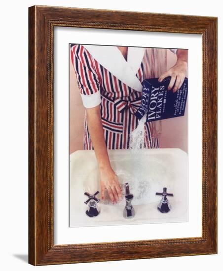 Woman in Red, White and Blue Robe Pouring Ivory Soap Flakes Into Bathroom Sink-Gjon Mili-Framed Photographic Print