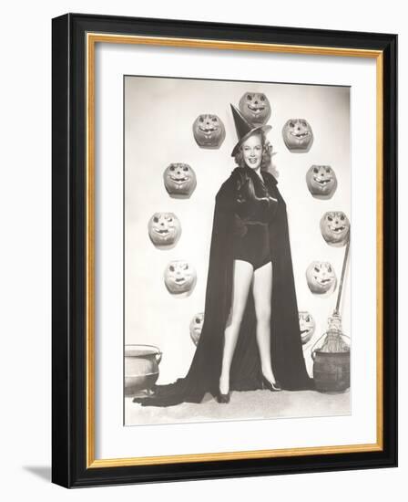 Woman in Witch Costume Surrounded by Carved Pumpkins-null-Framed Photo