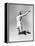 Woman Jumping into the Air with a Tennis Racket in Her Hand-null-Framed Stretched Canvas