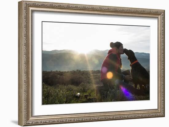 Woman Kisses Her Dog With The Sun Rising In The Mountains Behind Her-Hannah Dewey-Framed Photographic Print