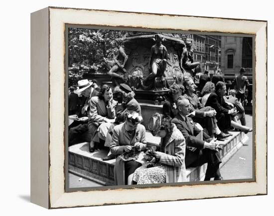 Woman Knitting Among Lunchtime Loungers Relaxing at Base of Statue at New York Public Library-Alfred Eisenstaedt-Framed Premier Image Canvas