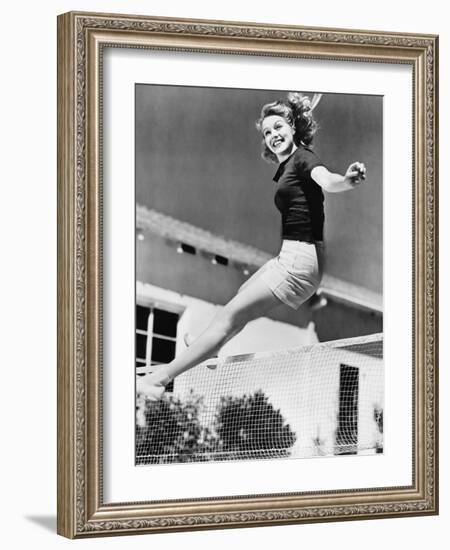 Woman Leaping over a Tennis Net-null-Framed Photo