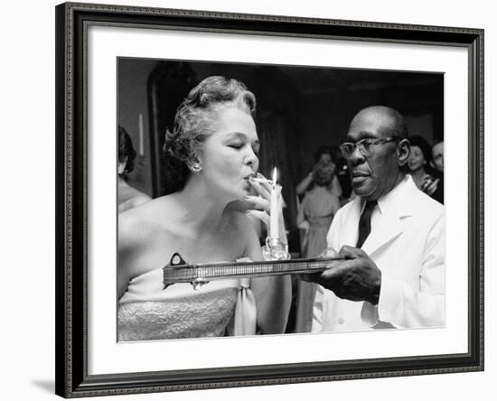 Woman Lighting a Cigarette from a Candle Held by a Waiter at the Piedmont Ball-Paul Schutzer-Framed Photographic Print