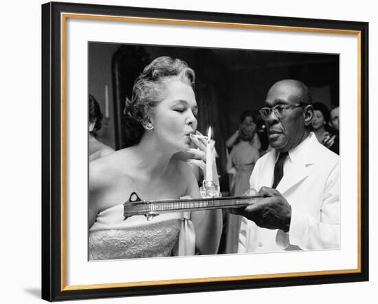 Woman Lighting a Cigarette from a Candle Held by a Waiter at the Piedmont Ball-Paul Schutzer-Framed Photographic Print