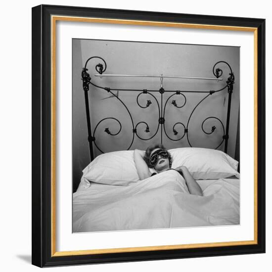 Woman Models Satin Edged Sleep Mask Displaying Lining of Gold Braid, Eyelashes and Twinkling Starts-Yale Joel-Framed Photographic Print