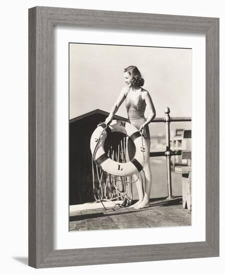 Woman on Pier Holding a Life Preserver-Everett Collection-Framed Photographic Print