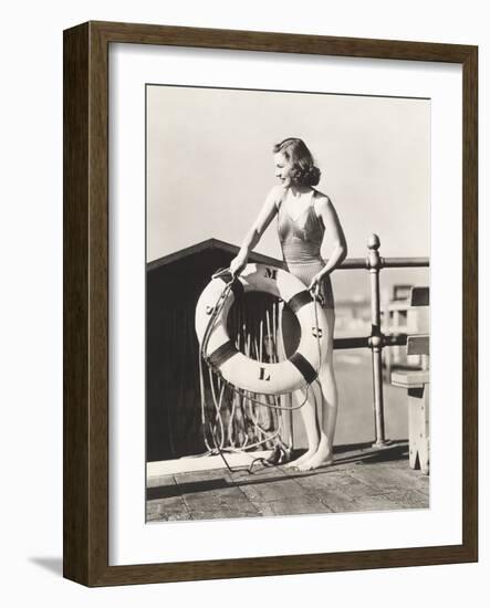 Woman on Pier Holding a Life Preserver-Everett Collection-Framed Photographic Print