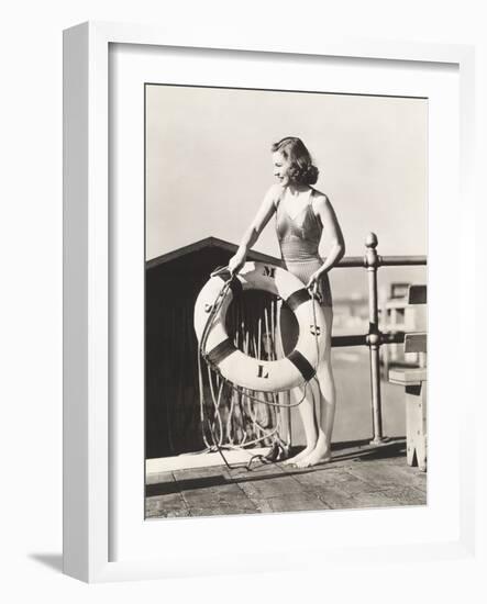 Woman on Pier Holding a Life Preserver-Everett Collection-Framed Photographic Print