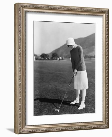 Woman Playing Golf-null-Framed Photo