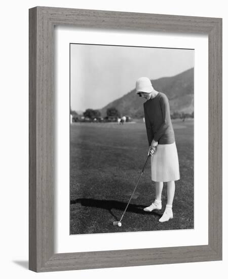 Woman Playing Golf-null-Framed Photo