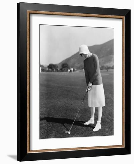 Woman Playing Golf-null-Framed Photo