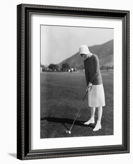 Woman Playing Golf-null-Framed Photo