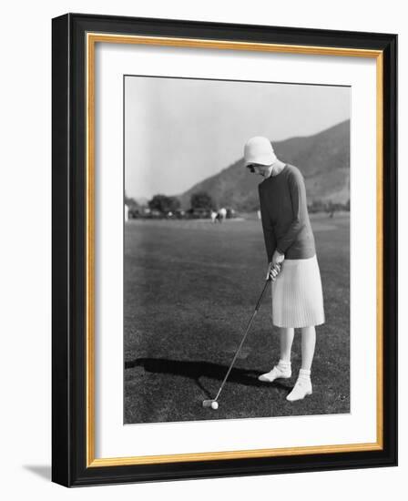 Woman Playing Golf-null-Framed Photo