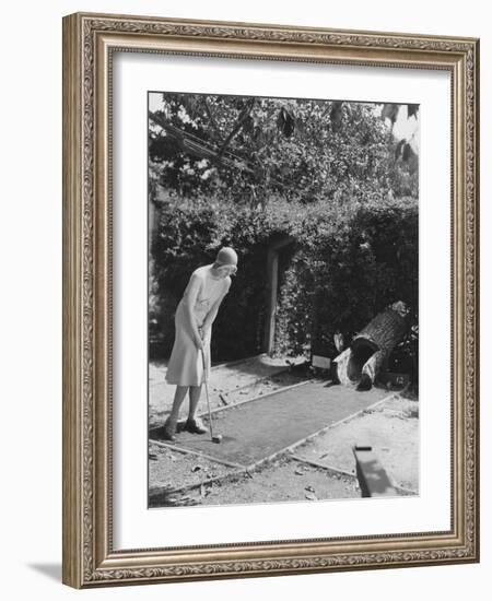 Woman Playing Miniature Golf-null-Framed Photo