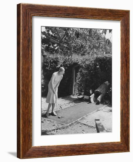 Woman Playing Miniature Golf-null-Framed Photo