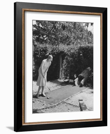 Woman Playing Miniature Golf-null-Framed Photo