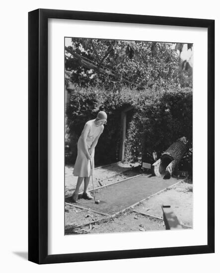 Woman Playing Miniature Golf-null-Framed Photo