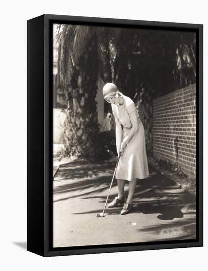 Woman Playing Miniature Golf-null-Framed Stretched Canvas