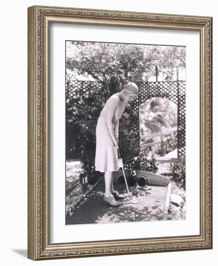 Woman Playing Miniature Golf-null-Framed Photo