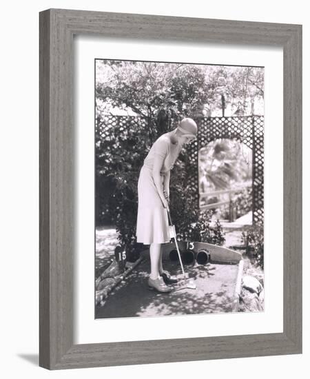 Woman Playing Miniature Golf-null-Framed Photo