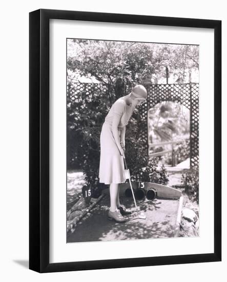 Woman Playing Miniature Golf-null-Framed Photo