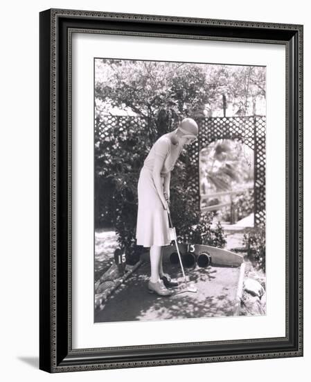 Woman Playing Miniature Golf-null-Framed Photo