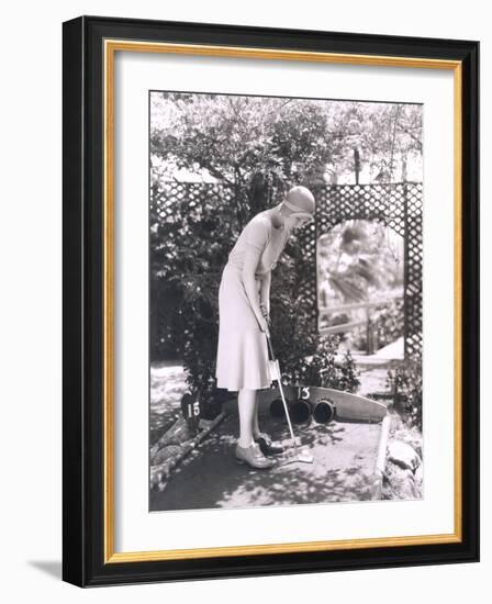 Woman Playing Miniature Golf-null-Framed Photo