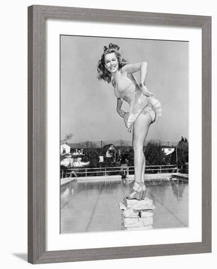 Woman Posing on Top of a Pillar Next to a Swimming Pool-null-Framed Photo