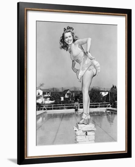Woman Posing on Top of a Pillar Next to a Swimming Pool-null-Framed Photo