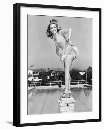 Woman Posing on Top of a Pillar Next to a Swimming Pool-null-Framed Photo