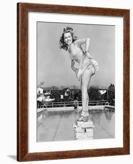 Woman Posing on Top of a Pillar Next to a Swimming Pool-null-Framed Photo