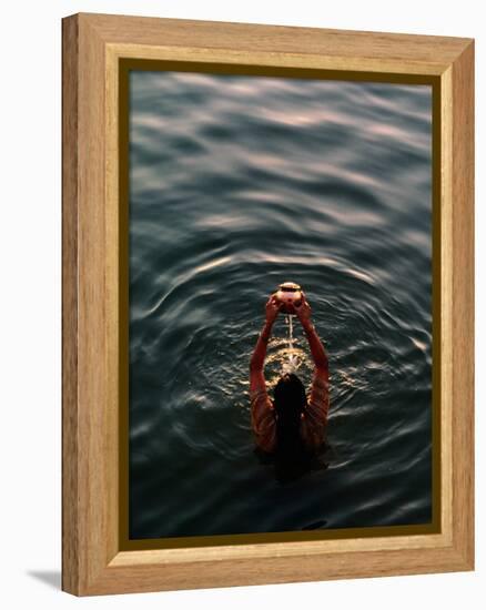 Woman Pouring Water During Morning Puja on Ganges, Varanasi, India-Anthony Plummer-Framed Premier Image Canvas