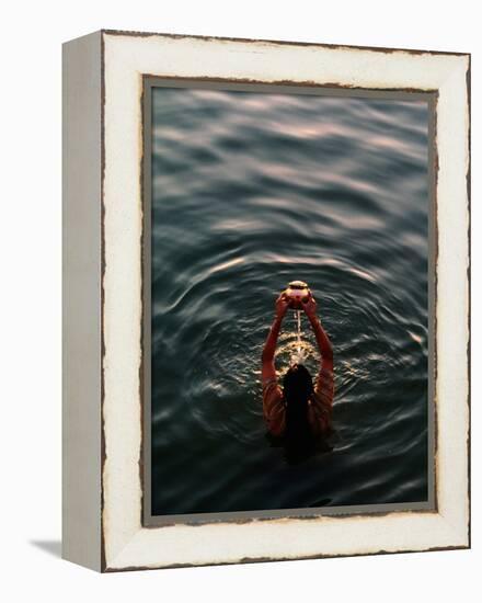 Woman Pouring Water During Morning Puja on Ganges, Varanasi, India-Anthony Plummer-Framed Premier Image Canvas