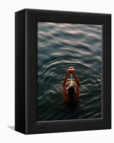 Woman Pouring Water During Morning Puja on Ganges, Varanasi, India-Anthony Plummer-Framed Premier Image Canvas