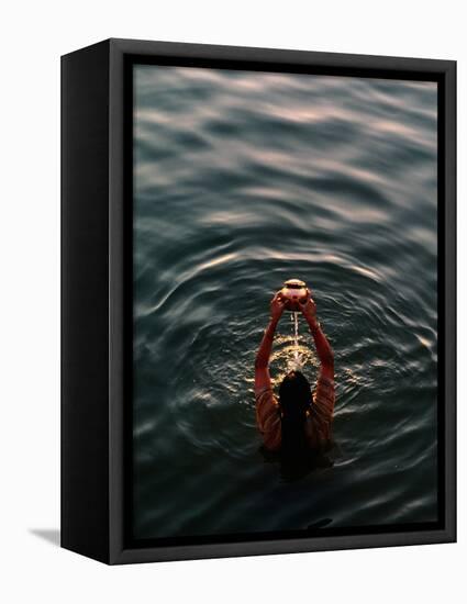 Woman Pouring Water During Morning Puja on Ganges, Varanasi, India-Anthony Plummer-Framed Premier Image Canvas