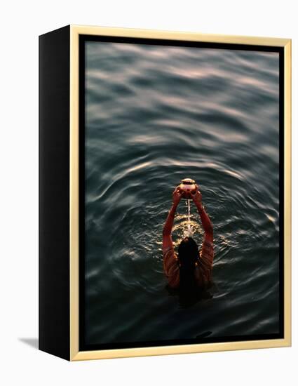 Woman Pouring Water During Morning Puja on Ganges, Varanasi, India-Anthony Plummer-Framed Premier Image Canvas